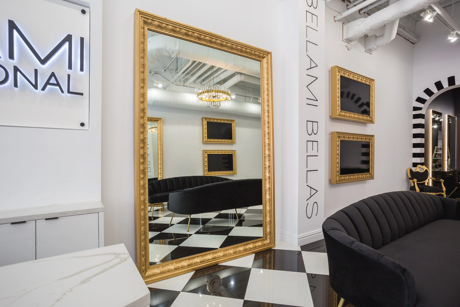 Luxury salon interior with a gold-framed mirror, black velvet seating, and checkered flooring for an elegant decor.