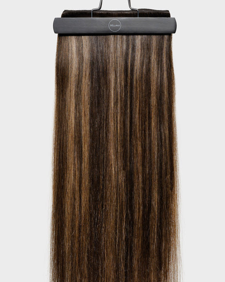 BELLAMI Flex Weft 2.0 hair extensions in Chocolate Rebel (#1C/24/18/46/4), a hybrid blend of multiple tones, hanging at full length from a BELLAMI display hanger.